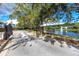 The community entrance features iron gates, a landscaped median, and a serene pond with a water fountain at 5524 Salem Square N Dr, Palm Harbor, FL 34685