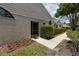 Exterior of home with mature landscaping including green hedges and flower beds at 5524 Salem Square N Dr, Palm Harbor, FL 34685