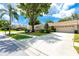 Single Gathering home with well-manicured front yard, mature landscaping, and attached garage at 5524 Salem Square N Dr, Palm Harbor, FL 34685