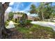 Well-maintained villa featuring a two-car garage and manicured landscaping at 5524 Salem Square N Dr, Palm Harbor, FL 34685
