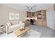 Carpeted office featuring built-in shelving, white sofa, and a large window at 5524 Salem Square N Dr, Palm Harbor, FL 34685