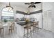 Eat-in kitchen with black countertops, an island and four-chair seating, and stainless appliances at 5524 Salem Square N Dr, Palm Harbor, FL 34685