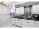 Kitchen sink with black countertops, and stainless steel appliances at 5524 Salem Square N Dr, Palm Harbor, FL 34685