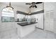 Eat-in kitchen with black countertops, an island and four-chair seating, and stainless appliances at 5524 Salem Square N Dr, Palm Harbor, FL 34685