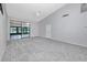 Spacious living room with gray walls, carpet and sliding glass doors at 5524 Salem Square N Dr, Palm Harbor, FL 34685