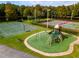 The community playground features green turf, playground equipment, a basketball court, and tennis courts at 5524 Salem Square N Dr, Palm Harbor, FL 34685
