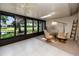 Relaxing sunroom with a tile floor, pond views, a skylight, and a dining table with chairs at 5524 Salem Square N Dr, Palm Harbor, FL 34685