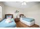 Comfortable bedroom with two twin beds and island-inspired decor at 600 71St Ave # 18, St Pete Beach, FL 33706