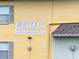 Close-up shot of building with 'Waves 600' signage, windows, and the building's color at 600 71St Ave # 18, St Pete Beach, FL 33706