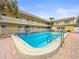 Relaxing community pool surrounded by sunny lounge chairs and lush landscaping at 600 71St Ave # 18, St Pete Beach, FL 33706