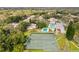 Aerial view showing tennis court, pool, houses and wooded area at 6206 Dewdrop Way # 0, Temple Terrace, FL 33617