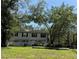 Two-story condo with green grass and beautiful green shady trees in the yard at 6206 Dewdrop Way # 0, Temple Terrace, FL 33617