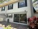 Outdoor patio with sliding glass doors, showing plants, outdoor space and upper windows at 6206 Dewdrop Way # 0, Temple Terrace, FL 33617