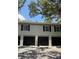 Three-unit garage doors in a condo or townhome, black doors and light trim at 6206 Dewdrop Way # 0, Temple Terrace, FL 33617