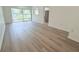 A well-lit living room with modern flooring and access to the backyard at 6206 Dewdrop Way # 0, Temple Terrace, FL 33617