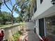 A private outdoor patio with greenery, tile flooring, and a partial privacy wall at 6206 Dewdrop Way # 0, Temple Terrace, FL 33617