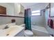 Traditional bathroom features a tub with shower, lavatory, and practical fixtures, designed for everyday functionality at 6406 Congress St, New Port Richey, FL 34653