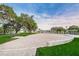 Outdoor community space with brick flooring, park benches and landscaped area at 6406 Congress St, New Port Richey, FL 34653