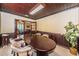 Conference room with wood-paneled walls, a large table, and an adjacent office space at 6406 Congress St, New Port Richey, FL 34653