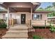 The home's covered porch has wood railing and provides a inviting entrance to the property at 6406 Congress St, New Port Richey, FL 34653