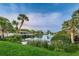 Picturesque lakeside view with lush greenery and a fountain in a serene community setting at 6406 Congress St, New Port Richey, FL 34653