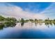 Scenic lake view with a fountain, surrounded by trees and buildings on a sunny day at 6406 Congress St, New Port Richey, FL 34653