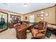 Well-lit office with wood desk, built-in shelving, and a comfortable leather chair, perfect for a productive workspace at 6406 Congress St, New Port Richey, FL 34653
