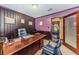 Traditional office space featuring a large desk, comfortable seating, and wood paneling, perfect for professional work at 6406 Congress St, New Port Richey, FL 34653