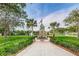 Park monument with US flag surrounded by green lawn, palm trees and walkway at 6406 Congress St, New Port Richey, FL 34653