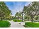 Serene park view with lush green grass, mature trees, and winding walking paths at 6406 Congress St, New Port Richey, FL 34653