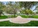 Green park featuring benches, mature trees, walkways, and a gazebo-like structure at 6406 Congress St, New Port Richey, FL 34653