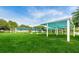 Scenic view of a public park with green grass, mature trees, and covered pavilions at 6406 Congress St, New Port Richey, FL 34653