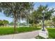 Scenic view of a public park with green grass, mature trees, sidewalks, and covered pavilions at 6406 Congress St, New Port Richey, FL 34653