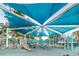 Community playground featuring a covered play structure with slides and climbing area at 6406 Congress St, New Port Richey, FL 34653