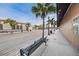 Street view showcasing the quaint street with palm trees and storefronts with benches at 6406 Congress St, New Port Richey, FL 34653