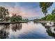 Picturesque waterfront view with boat docks, and waterfront homes against a colorful sky at 6406 Congress St, New Port Richey, FL 34653
