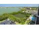 An aerial view showcases the waterfront property, highlighting the pool, foliage, and community at 7050 Sunset S Dr # 1401, South Pasadena, FL 33707