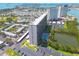 Aerial view of a high-rise condominium community with a pool, parking, and waterfront access at 7050 Sunset S Dr # 1401, South Pasadena, FL 33707