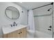 Bathroom features a wooden vanity with stone countertop and tiled shower at 7050 Sunset S Dr # 1401, South Pasadena, FL 33707