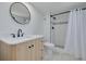 Beautiful bathroom features a modern vanity, round mirror, and updated shower with mosaic accents at 7050 Sunset S Dr # 1401, South Pasadena, FL 33707
