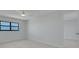 The bedroom offers bright light with neutral tones, modern fan and closet storage at 7050 Sunset S Dr # 1401, South Pasadena, FL 33707