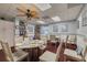 Inviting community room with ceiling fan, tables, chairs, bookshelves, and decor at 7050 Sunset S Dr # 1401, South Pasadena, FL 33707