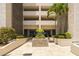 The exterior entrance is landscaped with palm trees and seasonal color at 7050 Sunset S Dr # 1401, South Pasadena, FL 33707