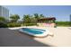 Outdoor hot tub with black wrought iron fence and wooden cabana, perfect for relaxation at 7050 Sunset S Dr # 1401, South Pasadena, FL 33707