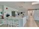 Full kitchen with long countertop, barstool seating, and modern appliances at 7050 Sunset S Dr # 1401, South Pasadena, FL 33707
