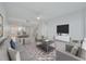 Spacious living room with modern decor, a large TV, and an adjacent dining area at 7050 Sunset S Dr # 1401, South Pasadena, FL 33707