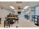 This bright lounge space offers multiple tables and chairs at 7050 Sunset S Dr # 1401, South Pasadena, FL 33707