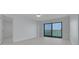 The main bedroom has a view and private balcony access with modern flooring and fan at 7050 Sunset S Dr # 1401, South Pasadena, FL 33707