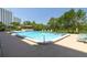 Large swimming pool surrounded by trees and a community building at 7050 Sunset S Dr # 1401, South Pasadena, FL 33707