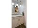 White bathroom vanity with granite countertop and modern lighting at 7360 Ulmerton Rd # 16A, Largo, FL 33771